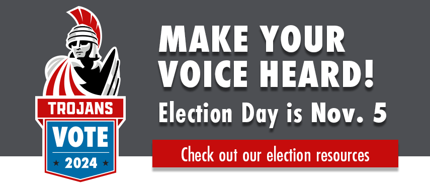 Trojans Vote 2024 promotional banner featuring a stylized illustration of a helmeted figure with a shield, encouraging electoral participation with the slogan 'MAKE YOUR VOICE HEARD!' and a reminder that Election Day is November 5. A button labeled 'Check out our election resources' is also displayed.