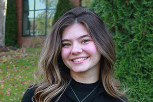 Camila Garcia Lemos in a grassy field outside of Parks Student Union.