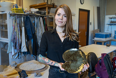 EvCC Ceramics student Jessica Mudd shows a lilly pad ceramics piece that is part of her upcoming show at Russell Day Gallery.