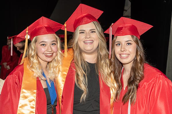 Jiahna Chapman (center) with classmates Lilyan Bek (right) and Hollee Seaward (center) at EvCC's 2022 commencement ceremony