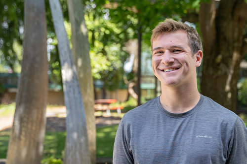 EvCC Student Trae Tinglestad stands in front of Jackson Conference Center. 