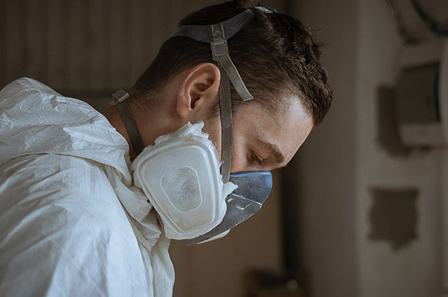 Man with a face mask works in advanced manufacturing.